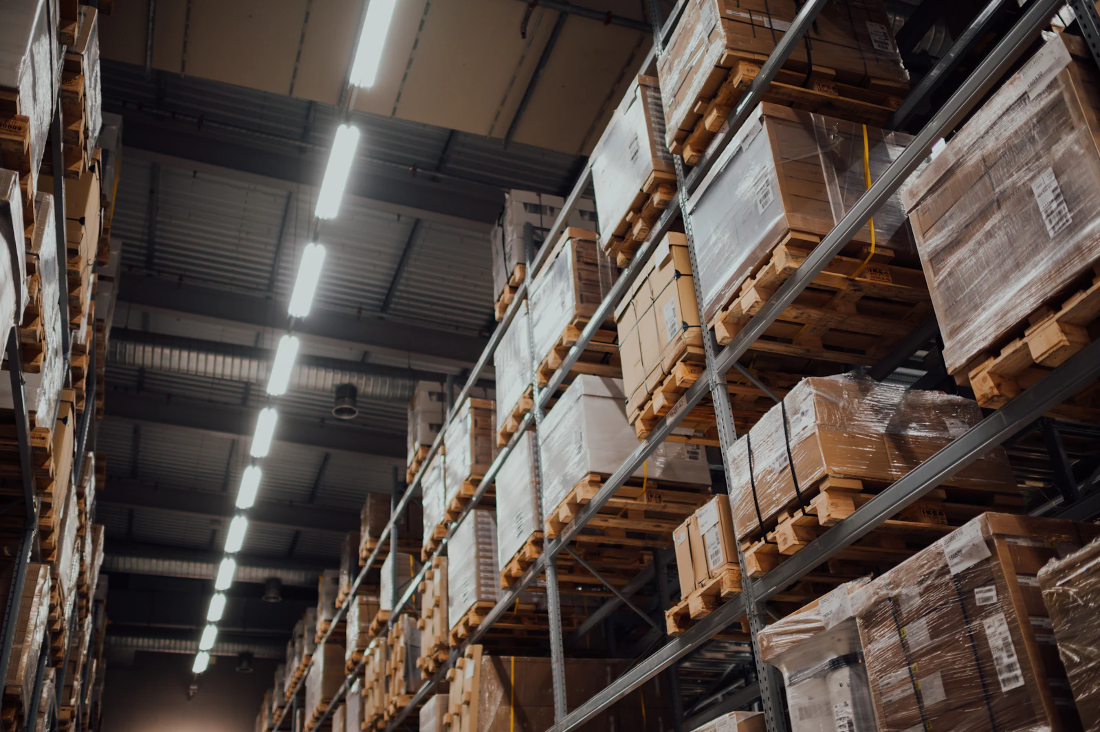 Tall warehouse racks stacked with cardboard boxes